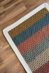 Close-up of corner of striped crochet blanket thumbnail