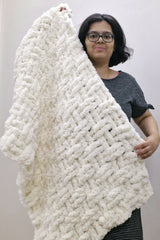 Woman holding cream colored crochet blanket thumbnail