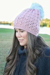 woman wearing a dusty pink crocheted beanie with a fur pom-pom thumbnail