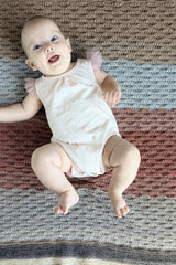 baby with almond stitch preemie baby blanket crochet in background thumbnail