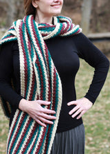 woman wearing a long teal, white, and red striped crocheted super scarf wrap outdoors thumbnail