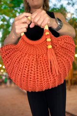 woman holding purse with two hands thumbnail
