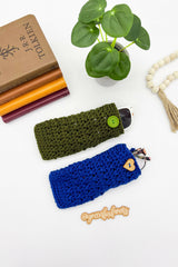 Crochet Cases Beside A Plant  thumbnail