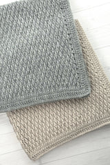 Crochet Blanket On A White Surface thumbnail