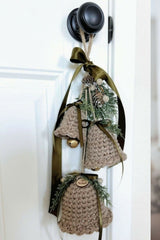 crocheted holiday bell ornament door hanger with green ribbon and evergreen sprigs thumbnail
