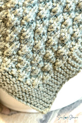 close-up of sage green knitted seersucker blanket edge showing textured stitch pattern and garter stitch border thumbnail