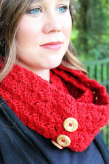 red crocheted tulip stitch cowl with brown wooden buttons worn by a woman outdoors thumbnail