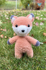 Fox stuffed animal standing in grass thumbnail