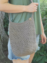 handmade mesh-style crocheted yarn market bag worn by woman thumbnail