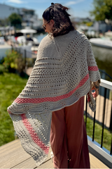 Woman wearing tan and pink shawl on a dock thumbnail