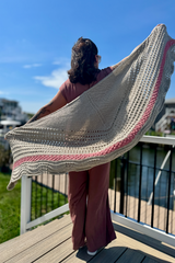 Woman wearing tan and pink shawl on a dock thumbnail