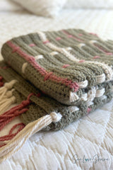crocheted sage green tartan plaid throw blanket featuring cream and rose woven vertical stripes and fringe tassel ends thumbnail
