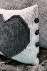 pillow with a heart and 4 buttons on a couch thumbnail
