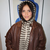 Woman in leather jacket wearing scarf/hood thumbnail