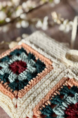 handmade crochet hearthside book sleeve made with modern granny squares in multicolor yarn thumbnail