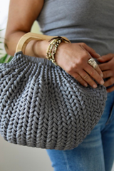 gray purse on woman's arm thumbnail