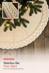 cream knitted tree skirt and table runner collection display showing matching cable braid designs thumbnail