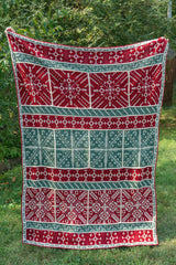 Handmade mosaic crochet blanket with snowflake squares and green red and cream yarn thumbnail