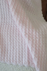 crochet baby blanket draped over chair thumbnail