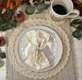 cream crocheted circular scalloped edge placemat and matching coaster on a textured table runner thumbnail
