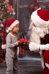 Knitted Hat Worn By A Child Beside Santa Claus thumbnail