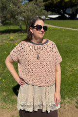 woman wearing a pink crocheted willow top outdoors thumbnail