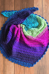 Handmade crochet triangle shawl showing bold self-striping color changes thumbnail