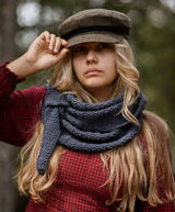 Woman wearing knit scarf in woods thumbnail