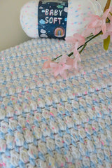 baby blanket shownn with baby soft yarn and pink flowers thumbnail