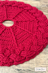 close up of handmade red and white cable braid crochet Christmas tree skirt thumbnail
