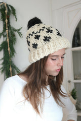woman wearing a cream and black houndstooth knitted beanie thumbnail