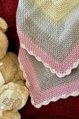 close up of handmade red and white cable braid crochet Christmas tree skirt thumbnail