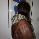 Woman in leather jacket wearing scarf/hood thumbnail