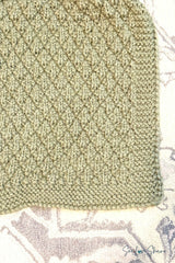 close-up of sage green knitted seersucker blanket edge showing textured stitch pattern and garter stitch border thumbnail