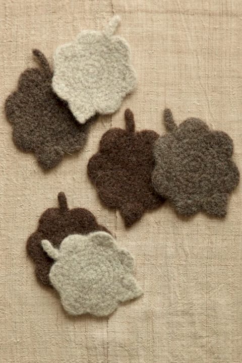 Black woman felting wool yarn on table