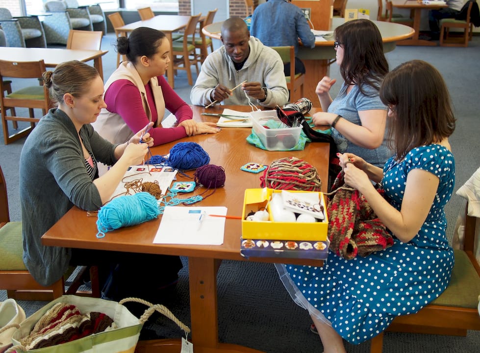 Hands knitting and crocheting different stitches