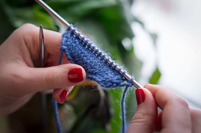 Woman knitting a sweater gauge swatch