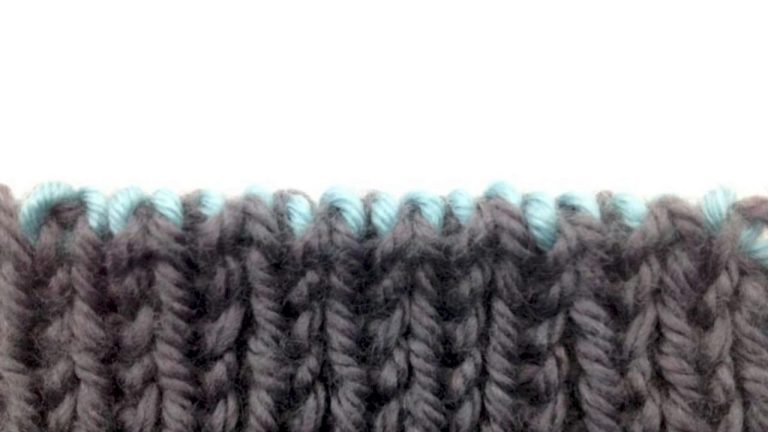 Knitter completing a clean bind off